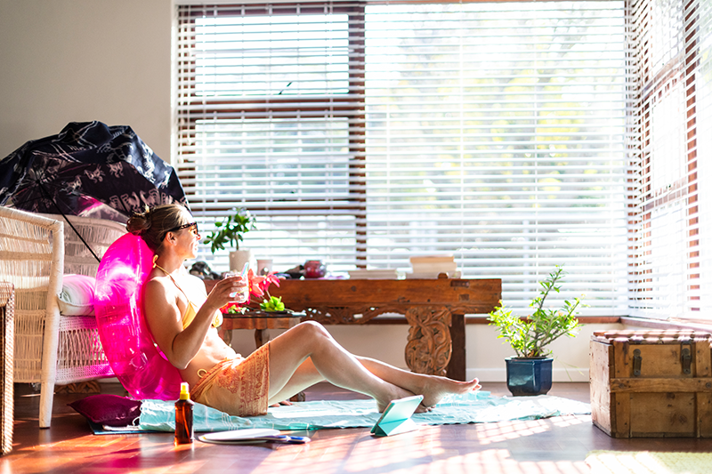 Summer Savings Tips for AC. Woman enjoying summer indoors.