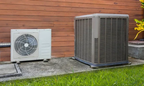 Heat pump next to AC unit
